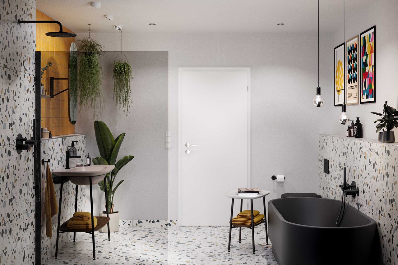 Salle de bain avec lavabo, baignoire, porte et sol en terrazzo