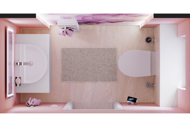 Vue plongeante d'une salle de bains avec lavabo, toilettes, baignoire et tapis de bain