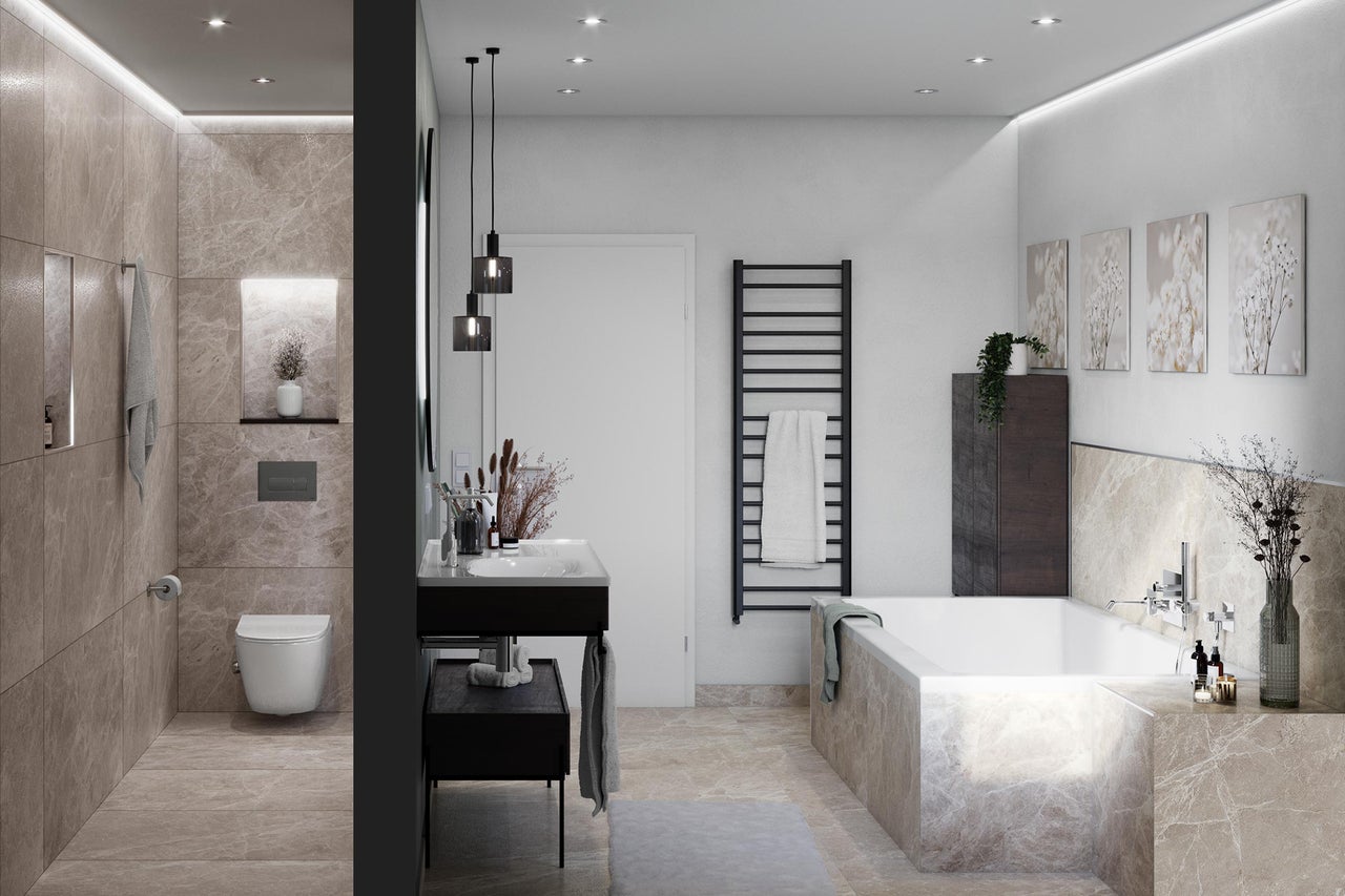 Salle de bains lumineuse avec baignoire, lavabo, toilettes et radiateur