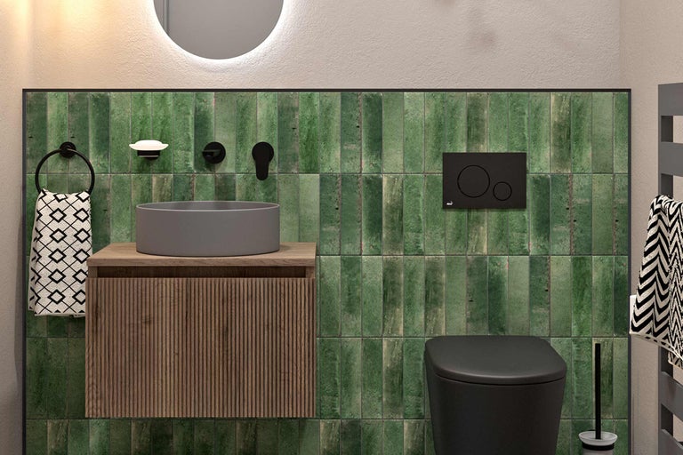 Salle de bains moderne avec lavabo, toilettes et carreaux verts