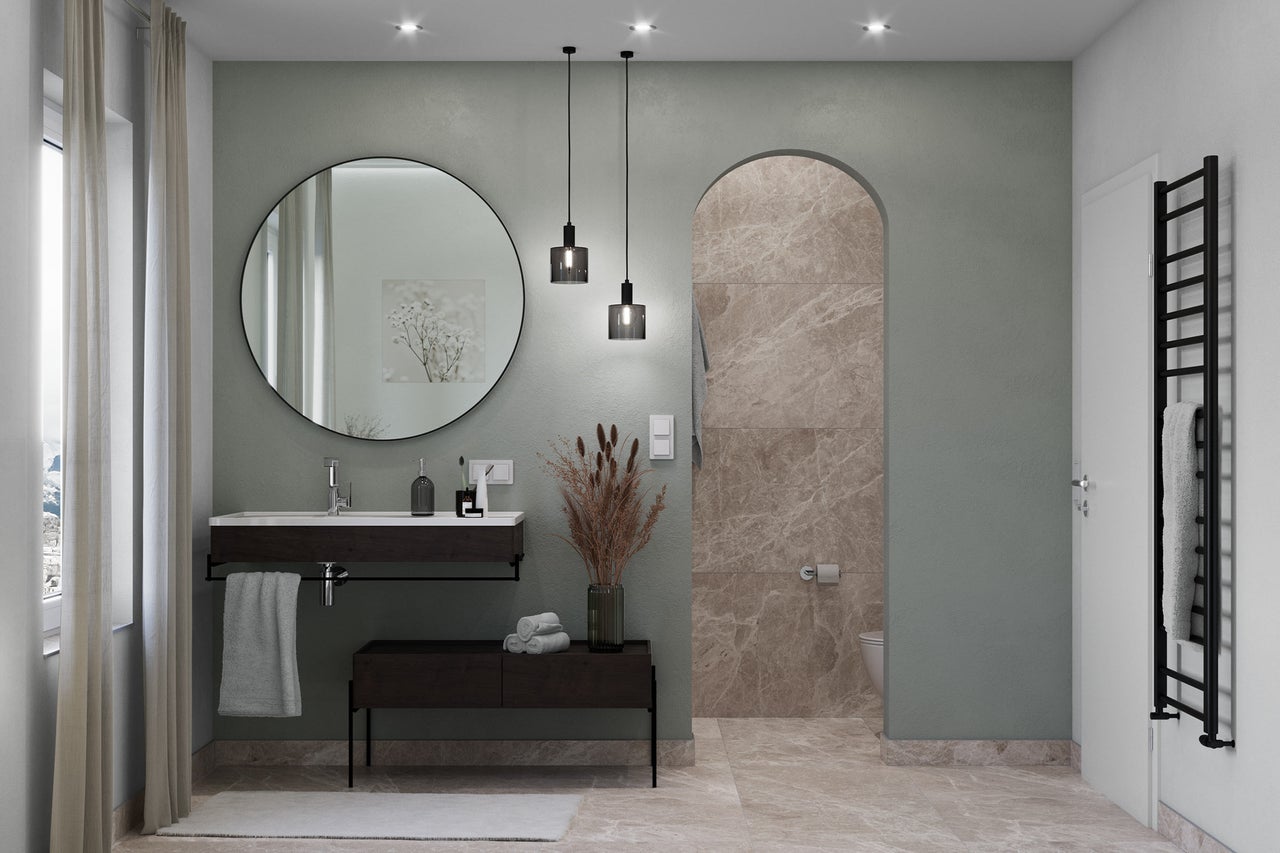 Salle de bain lumineuse avec lavabo, miroir, radiateur et carrelage