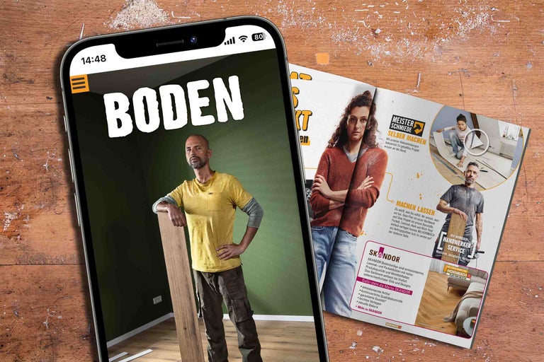 Un smartphone affiche une publicité pour les revêtements de sol à côté d'une brochure.