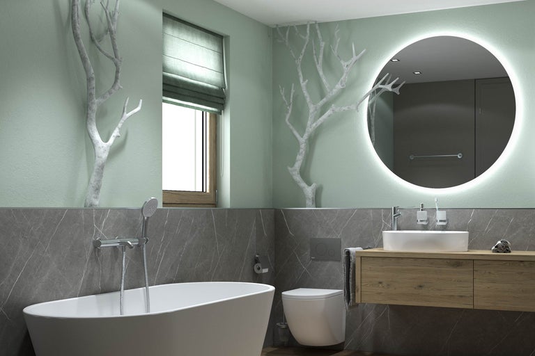 Salle de bains avec baignoire îlot, meuble-lavabo et miroir lumineux