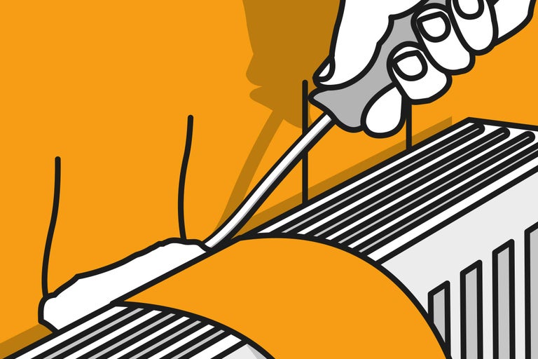 Une personne ajuste un robinet de radiateur avec un tournevis.