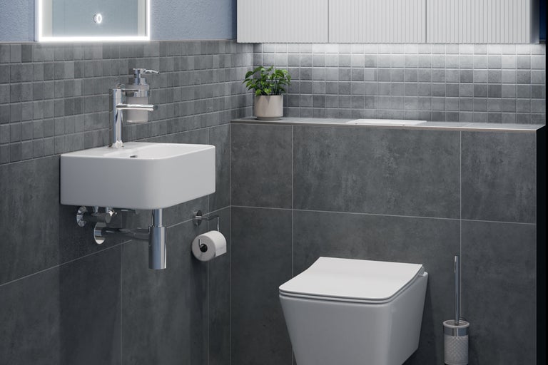 Badezimmer mit Waschbecken, Toilette und grauen Fliesen