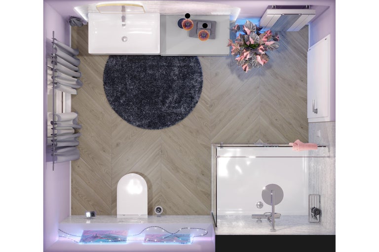 Vue de dessus d une salle de bains moderne avec carrelage imitation bois en chevrons, lavabo blanc, WC, douche en verre et tapis rond.
