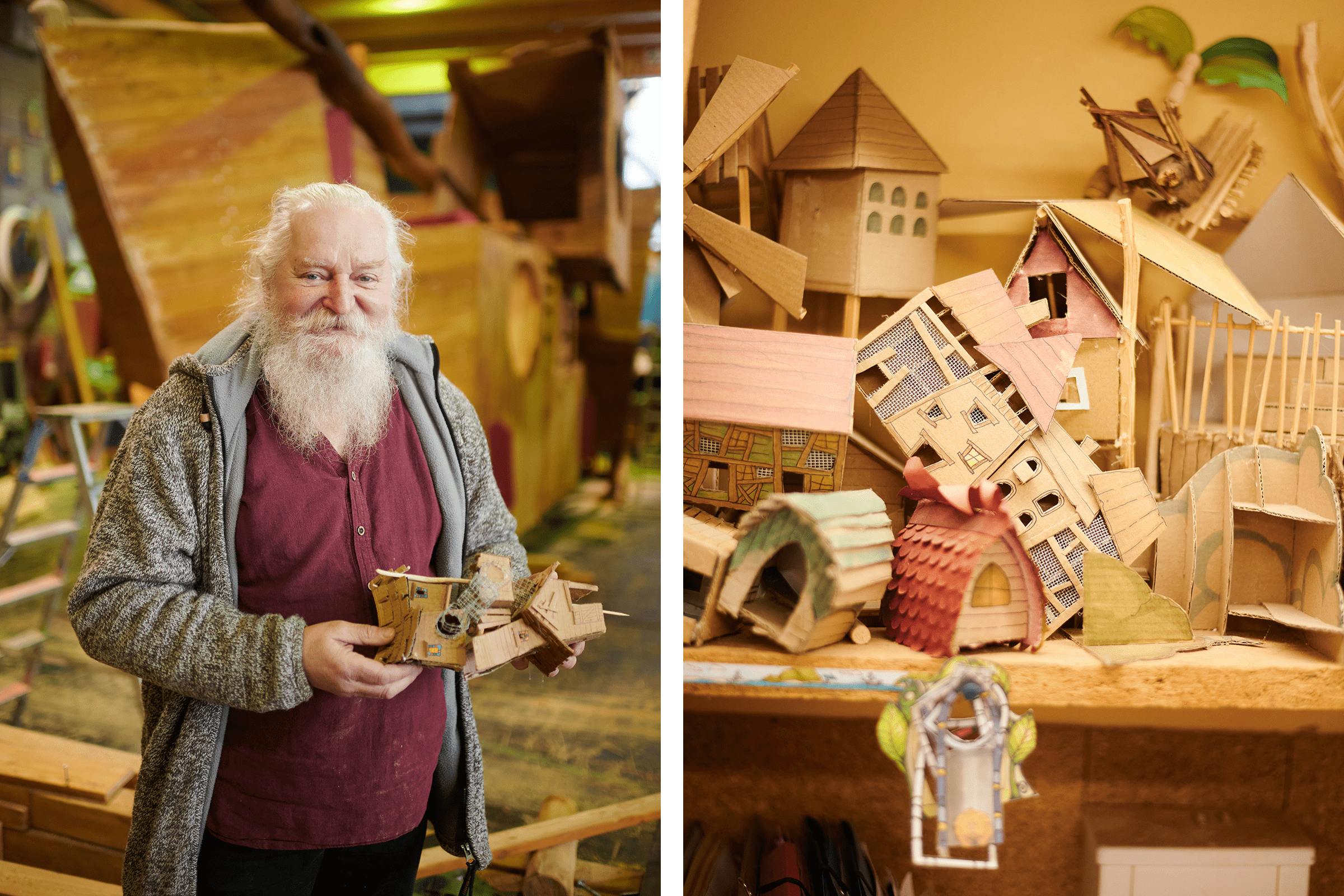 Mann mit Bart präsentiert ein Modellhaus aus Pappe, dahinter weitere Papphäuser