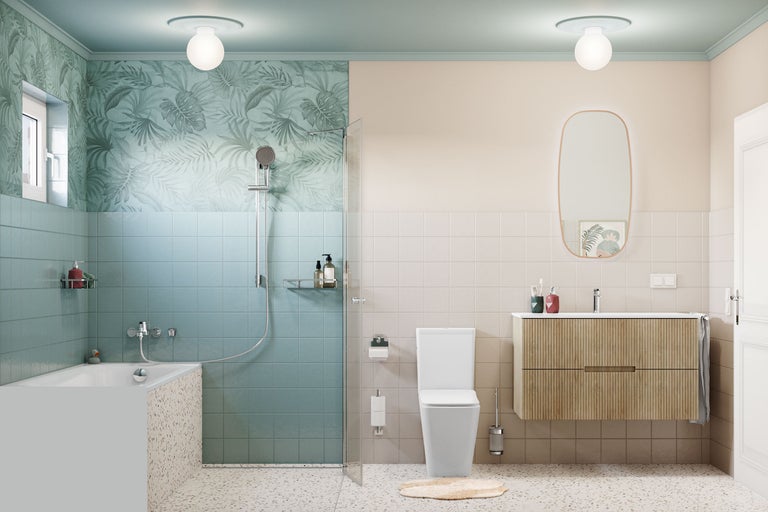 Salle de bains moderne et lumineuse avec carrelage bleu et beige, baignoire aspect terrazzo, douche à l'italienne, WC blanc et meuble en bois avec miroir.