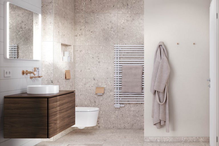 Salle de bain moderne avec meuble sous-vasque en bois foncé, vasque à poser blanche, miroir éclairé et carrelage en terrazzo grand format.