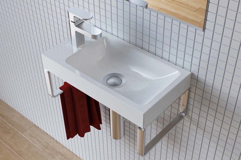 Lavabo avec robinet, serviette et porte-serviettes dans la salle de bain