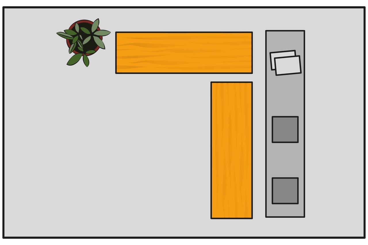 Vue de dessus d'un bureau d'angle avec plante, plateaux de bureau et caisson à roulettes