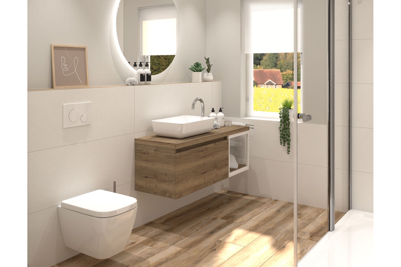 Salle de bain moderne avec meuble sous-vasque en bois, vasque à poser blanche, WC suspendu et miroir rond rétroéclairé sur carrelage clair.