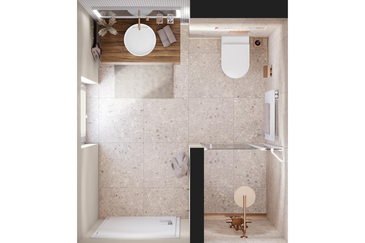 Vue de dessus d'une salle de bains moderne avec carrelage beige aspect pierre, meuble sous-vasque en bois, vasque blanche et robinetterie cuivrée.