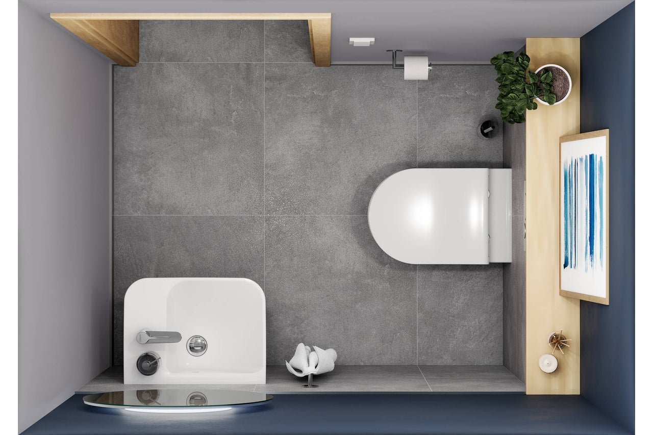 Vue de dessus d'une salle de bains avec toilettes, lavabo, étagères de rangement et décoration