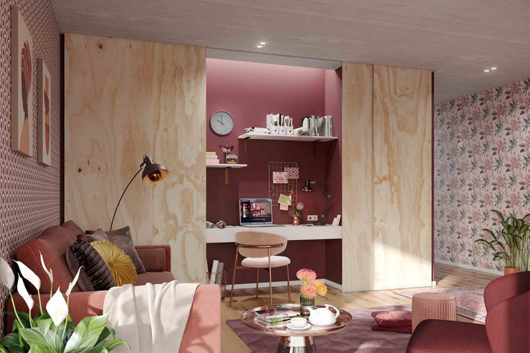 Salon avec espace de travail, canapé, table et mobilier de bureau dans un design clair et organisé.