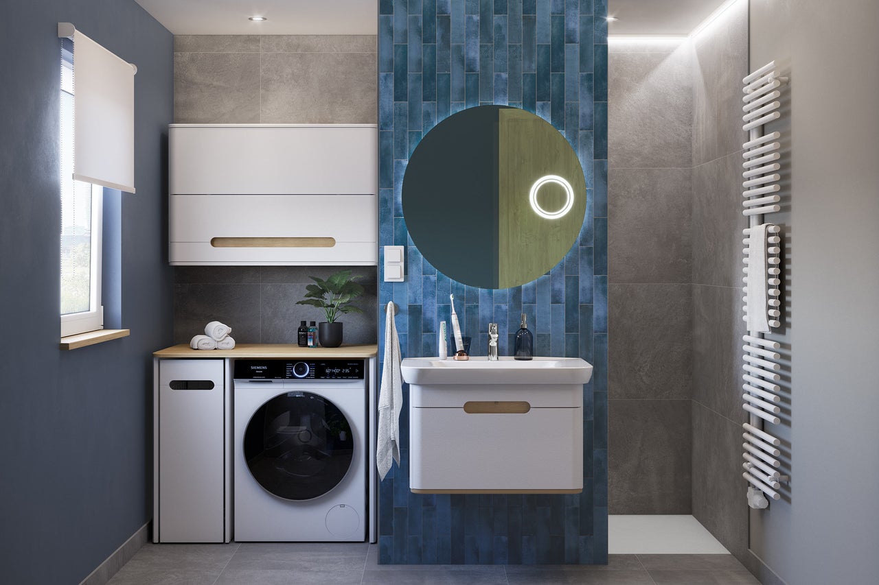Salle de bain moderne avec machine à laver, lavabo, miroir et radiateur