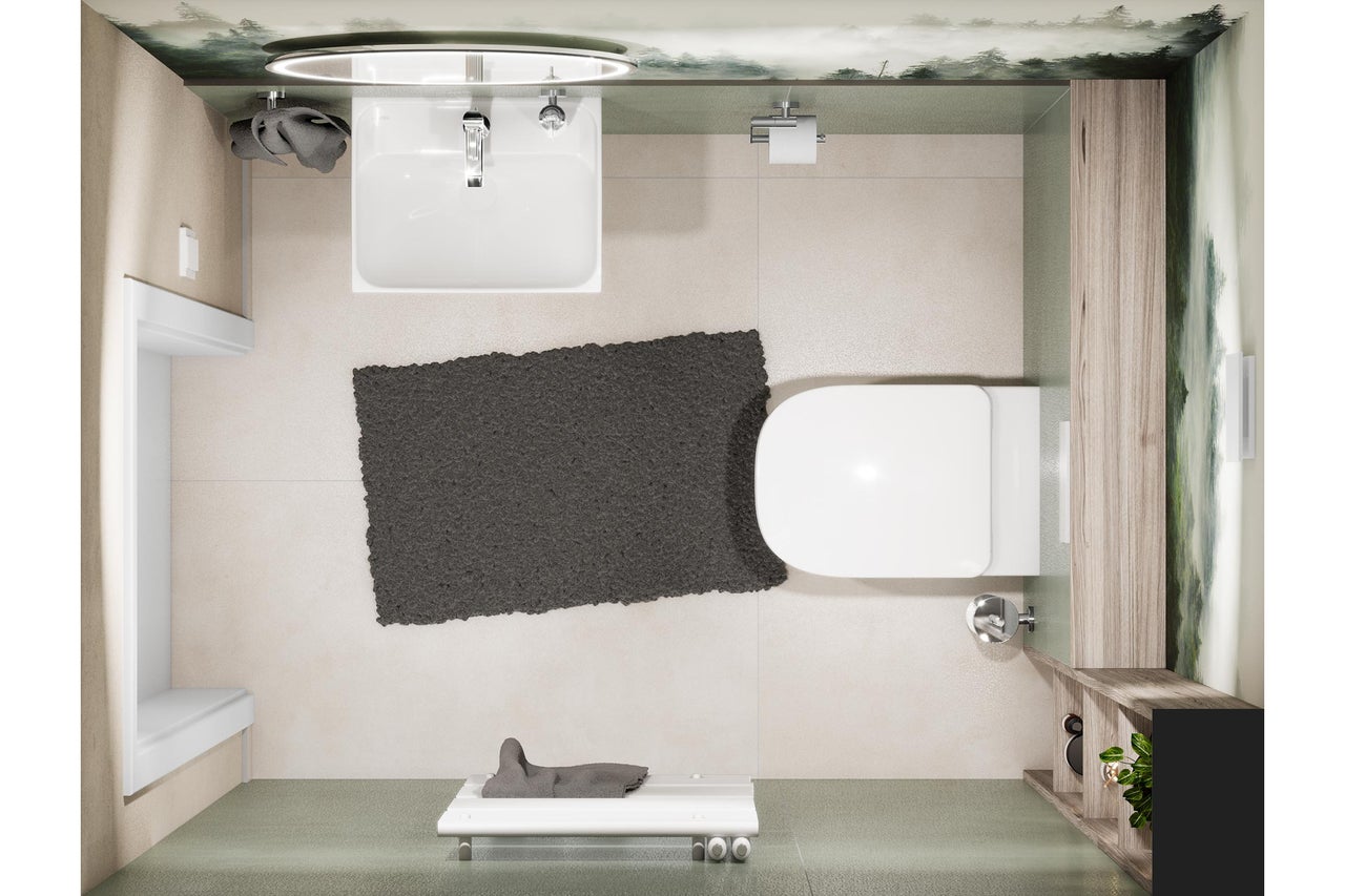 Vue plongeante d'une salle de bains avec lavabo, toilettes et tapis de bain