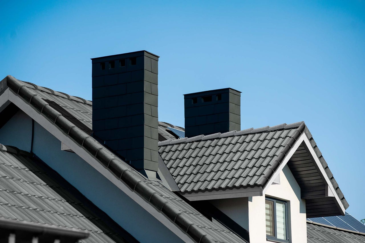 Dach eines Hauses mit Schornsteinen und Dachziegeln