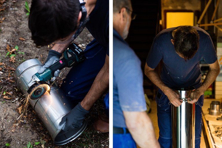Ein Mann schneidet ein Metallrohr mit einem Trennschleifer der Marke Makita. Auf der rechten Seite ist ein Mann zu sehen, der ein Metallrohr zusammenbaut.