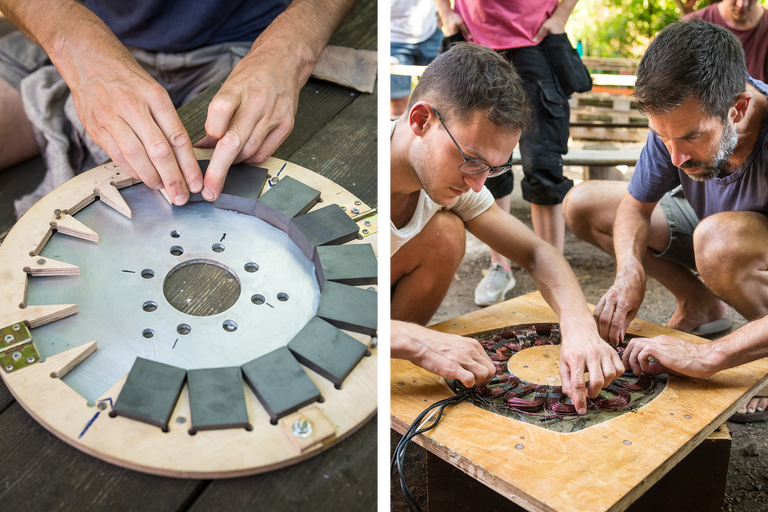 Auf einem Tisch montieren Personen Magnete und Spulen auf einer Scheibe.