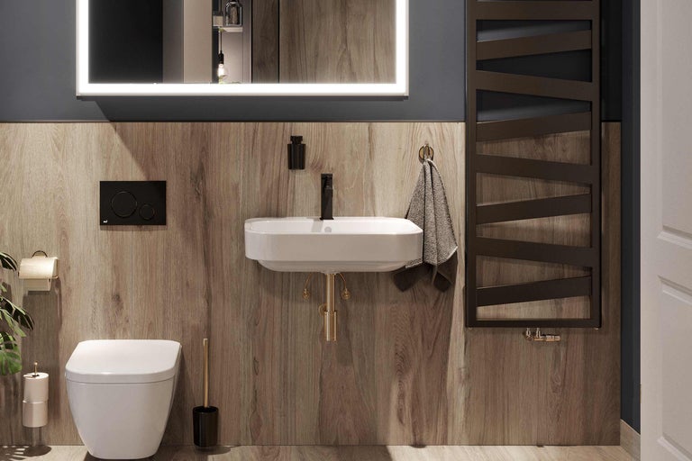 Salle de bains moderne avec toilettes, lavabo, miroir avec éclairage et radiateur