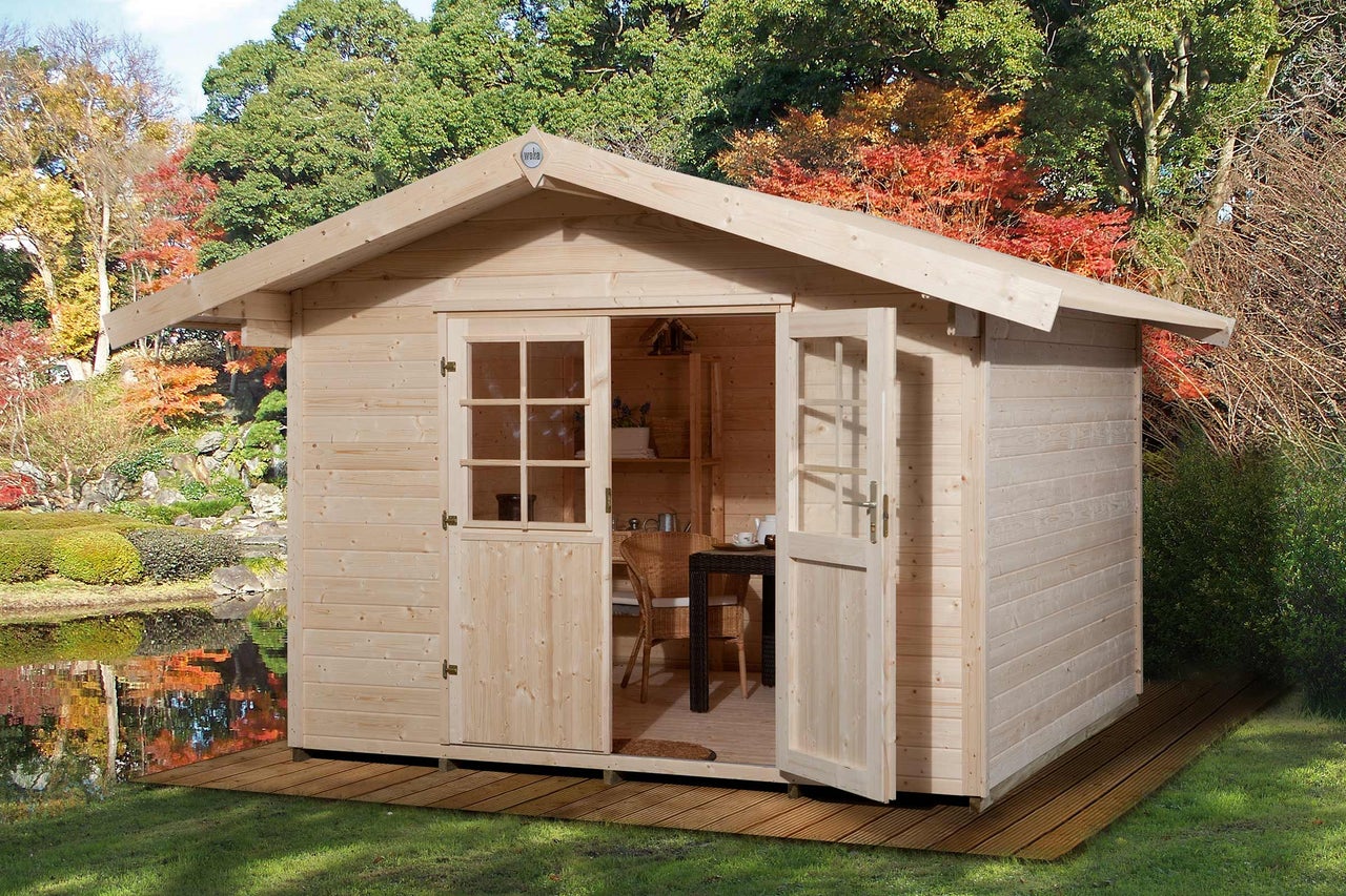 Abri de jardin en bois avec double porte et fenêtres dans le jardin