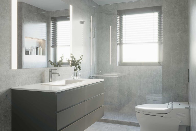 Salle de bains lumineuse avec lavabo, miroir, douche et toilettes au design moderne