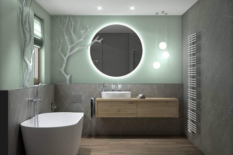Salle de bain lumineuse avec baignoire, meuble-lavabo, miroir avec éclairage et radiateur