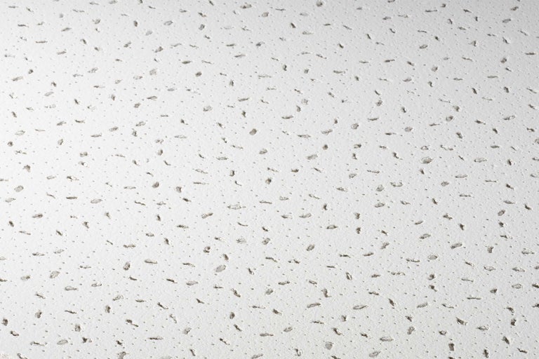 Gros plan d'un plafond acoustique avec des trous pour l'absorption acoustique