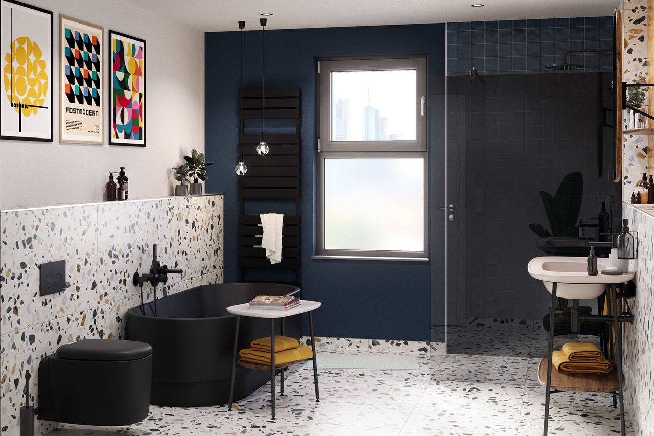 Salle de bains moderne avec baignoire îlot, toilettes, lavabo et sol en terrazzo