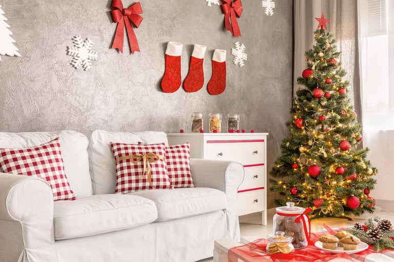 Salon décoré pour Noël avec canapé, sapin de Noël et décorations
