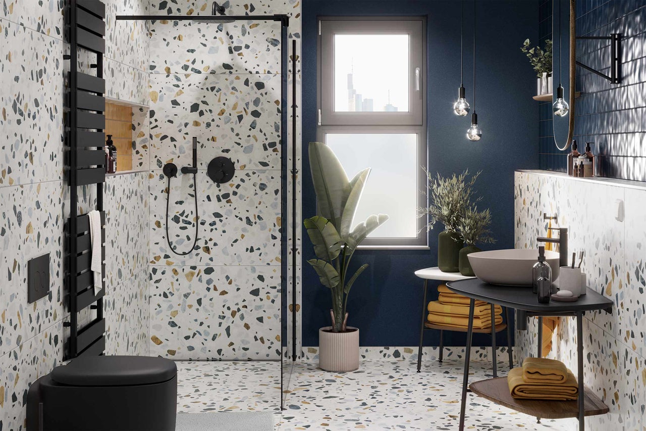 Salle de bains moderne avec sol et murs en terrazzo, douche, toilettes et lavabo