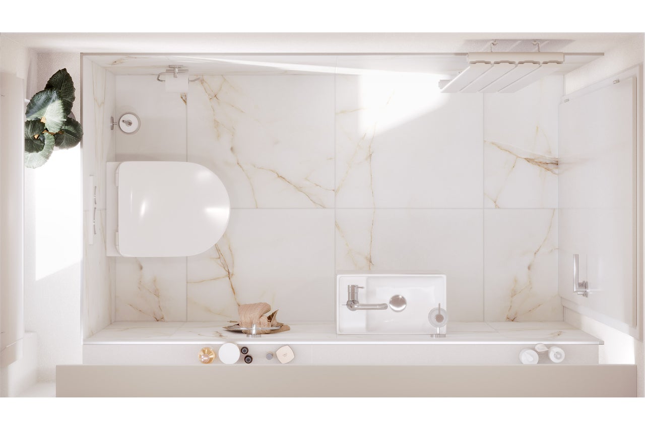 Vue d'ensemble d'une salle de bains avec toilettes, lavabo et douche