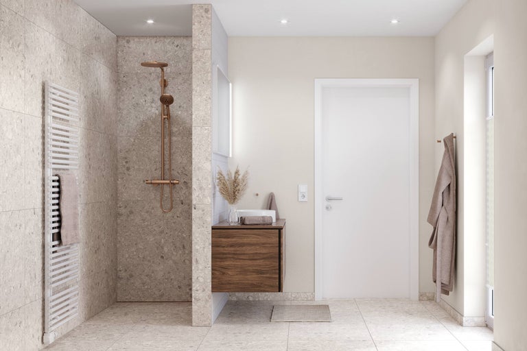 Salle de bains moderne avec douche à l'italienne, carrelage en terrazzo, robinetterie en cuivre et meuble sous-lavabo en bois.