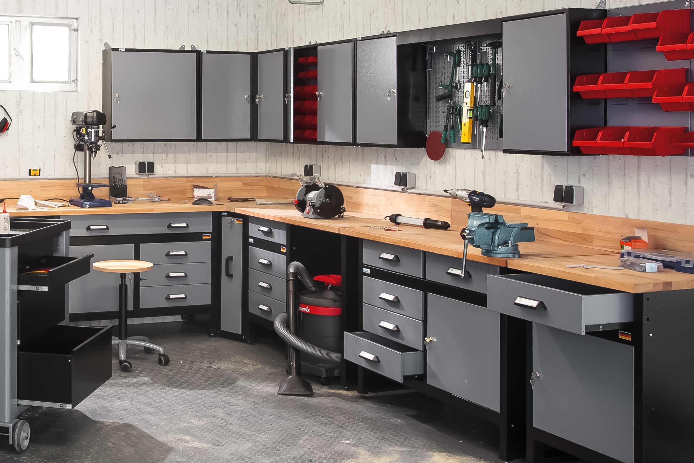 Werkstatt mit Werkbank, Werkzeugschrank, Werkzeugwand und Werkzeugen.