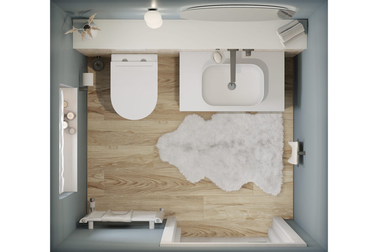 Vue de dessus d'une salle de bains avec toilettes, lavabo, baignoire et tapis de bain