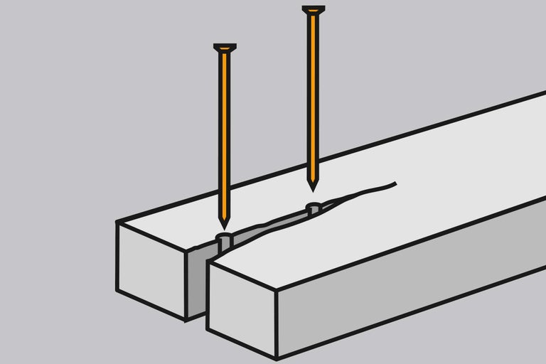 Zwei Nägel in einem Holzstück