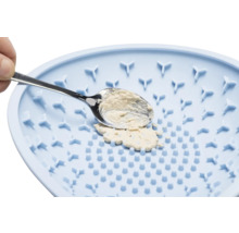 Hundenapf mit langsamer Fütterung und Futter auf einem Löffel