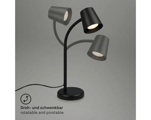 Schwarze Tischleuchte mit drei schwenkbaren Leuchtenköpfen zur flexiblen Ausrichtung des Lichts