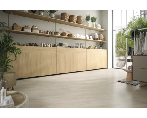 Heller Raum mit Holzregalen, Kommode und großem Fenster.