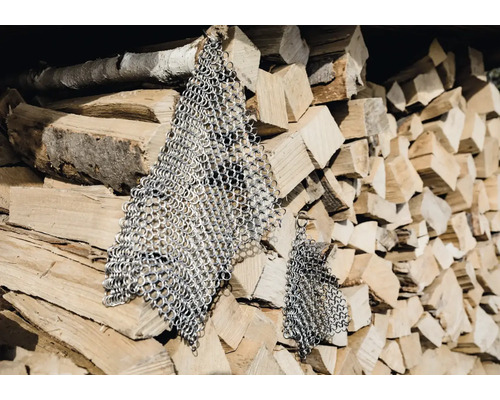 Treillis métallique devant une pile de bois