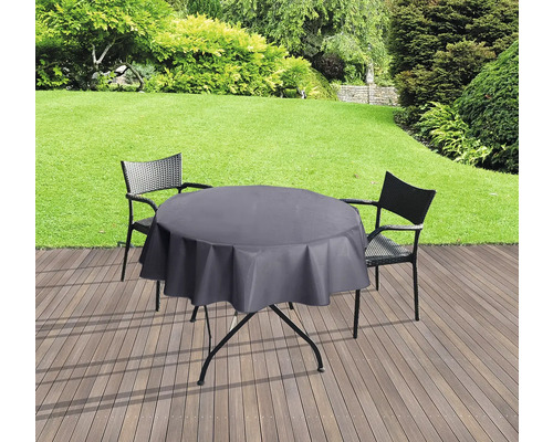 Scène de jardin avec table, chaises et nappe ronde pour l''extérieur.
