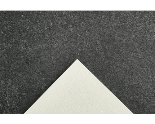 Detailaufnahme einer Bodenfliese mit gesprenkelter Oberfläche