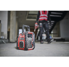 Une radio de chantier de la marque Einhell se trouve sur le sol d''un bâtiment en construction.
