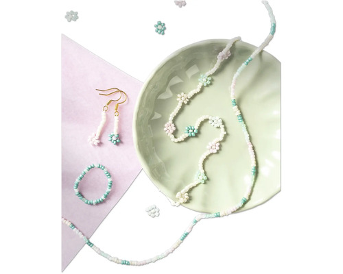 Ensemble de bijoux en perles avec collier, bague et boucles d''oreilles dans un bol vert clair