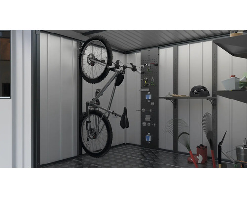 Vélo monté sur le support mural dans une remise de jardin, avec des étagères et un rangement pour outils.