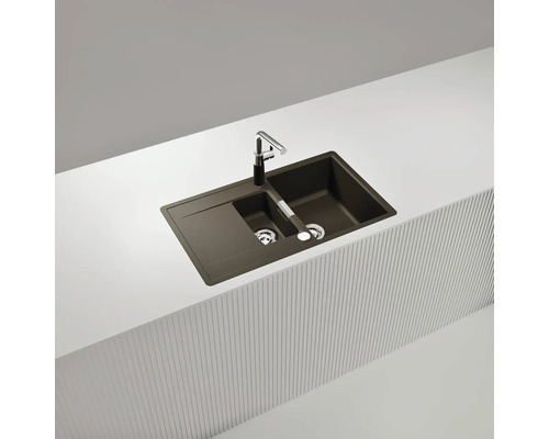 Spüle aus Verbundmaterial mit Abtropffläche und Armatur auf einer Arbeitsplatte