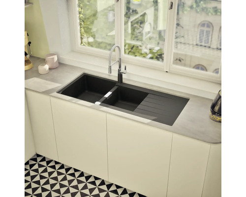 Évier à deux bacs et égouttoir sous une fenêtre dans une cuisine