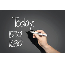 Eine Person schreibt mit einem Kreidemarker die Uhrzeiten 15:30 und 16:30 und das Wort Heute auf eine Tafel.