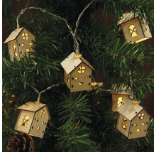 Guirlande lumineuse avec des motifs de maison sur un sapin de Noël